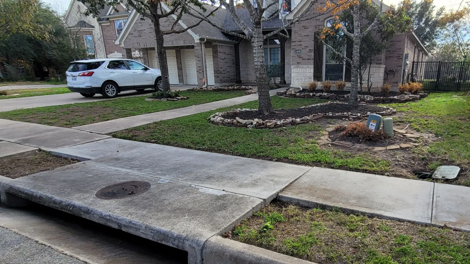 Same front yard after cleanup — leaves cleared, beds edged
