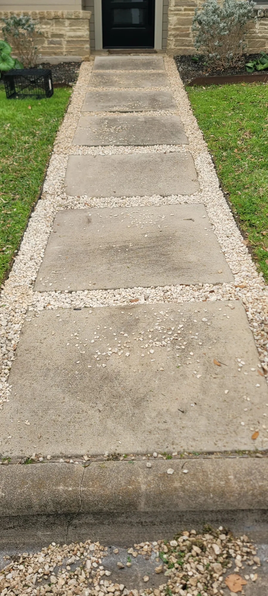 Same walkway after pressure washing — stone clean, gravel edging crisp